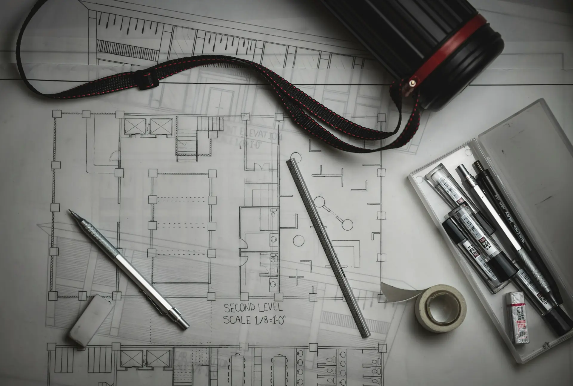 Architectural drawings with drafting pencils and a ruler
