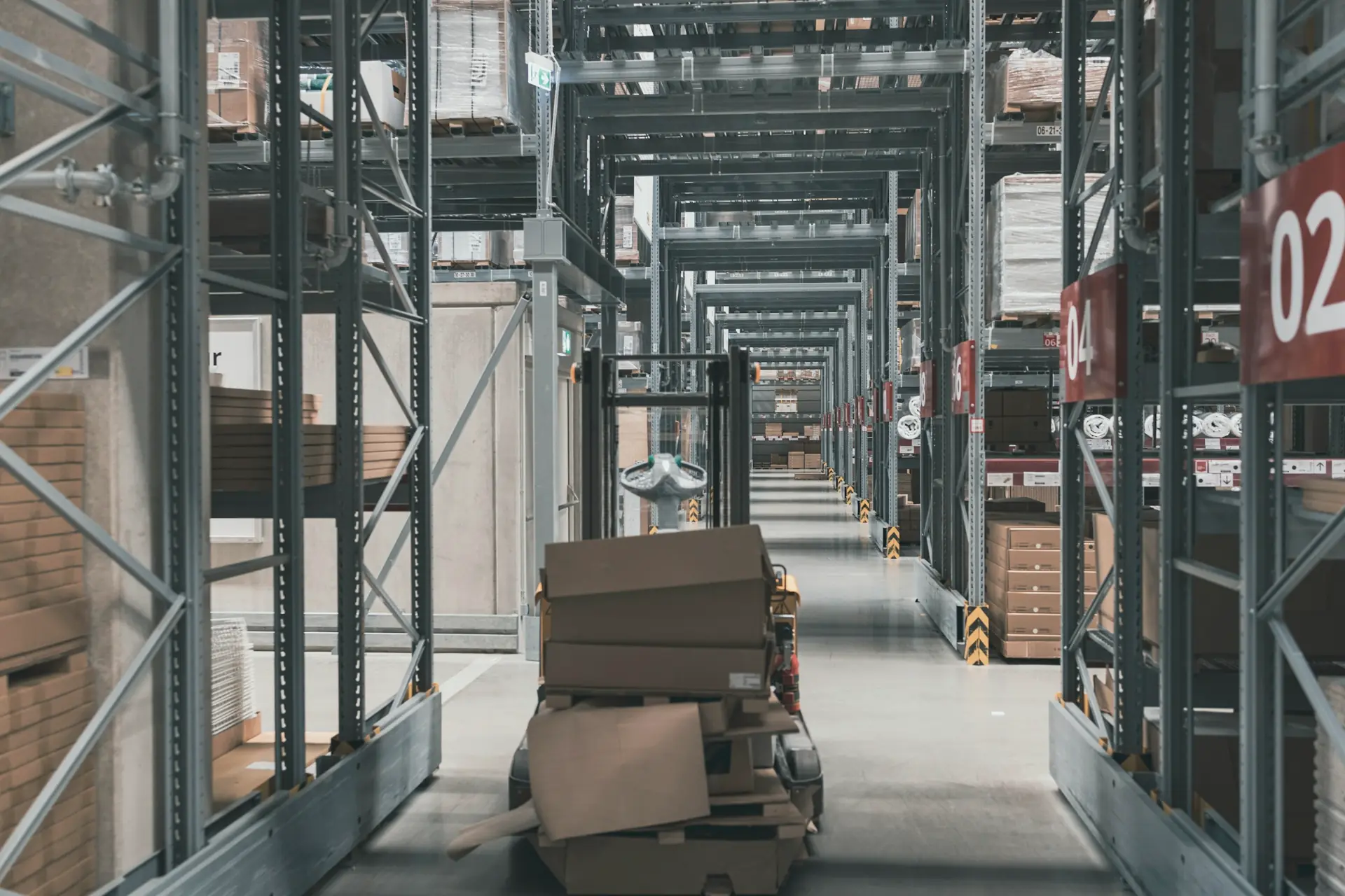 Warehouse aisle with tall racking and cartons