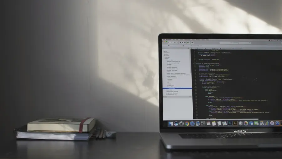 Laptop displaying source code on a quiet desk