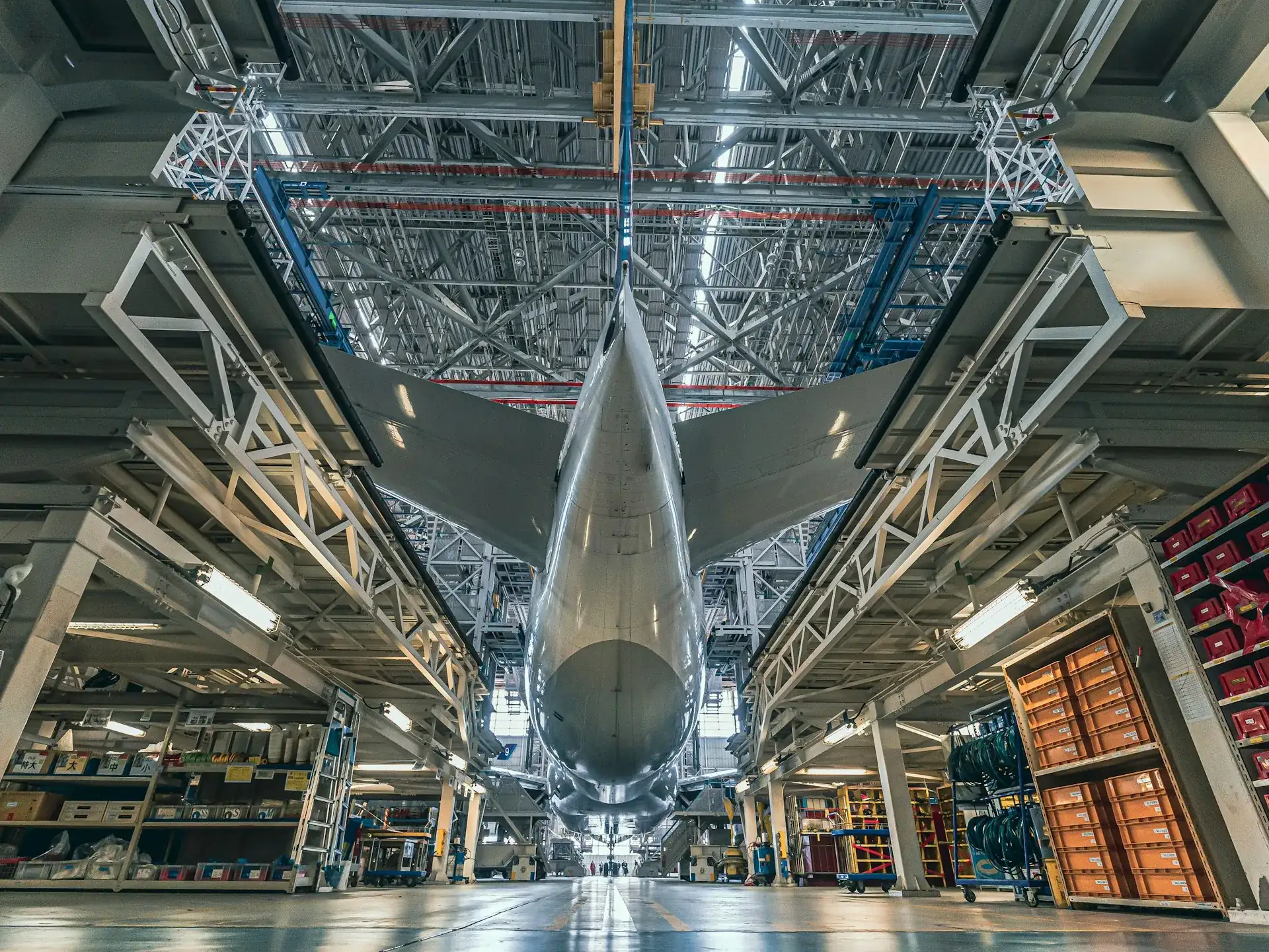 Jetliner in its assembly dock, seen from below the tail